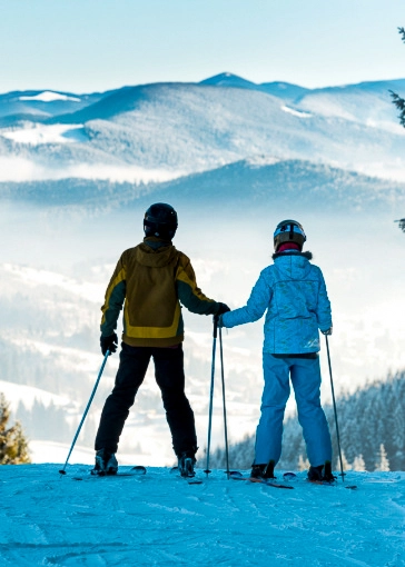 skier couple on top of a mountain
